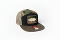 Camouflage trucker hat with fish patch on a dark background