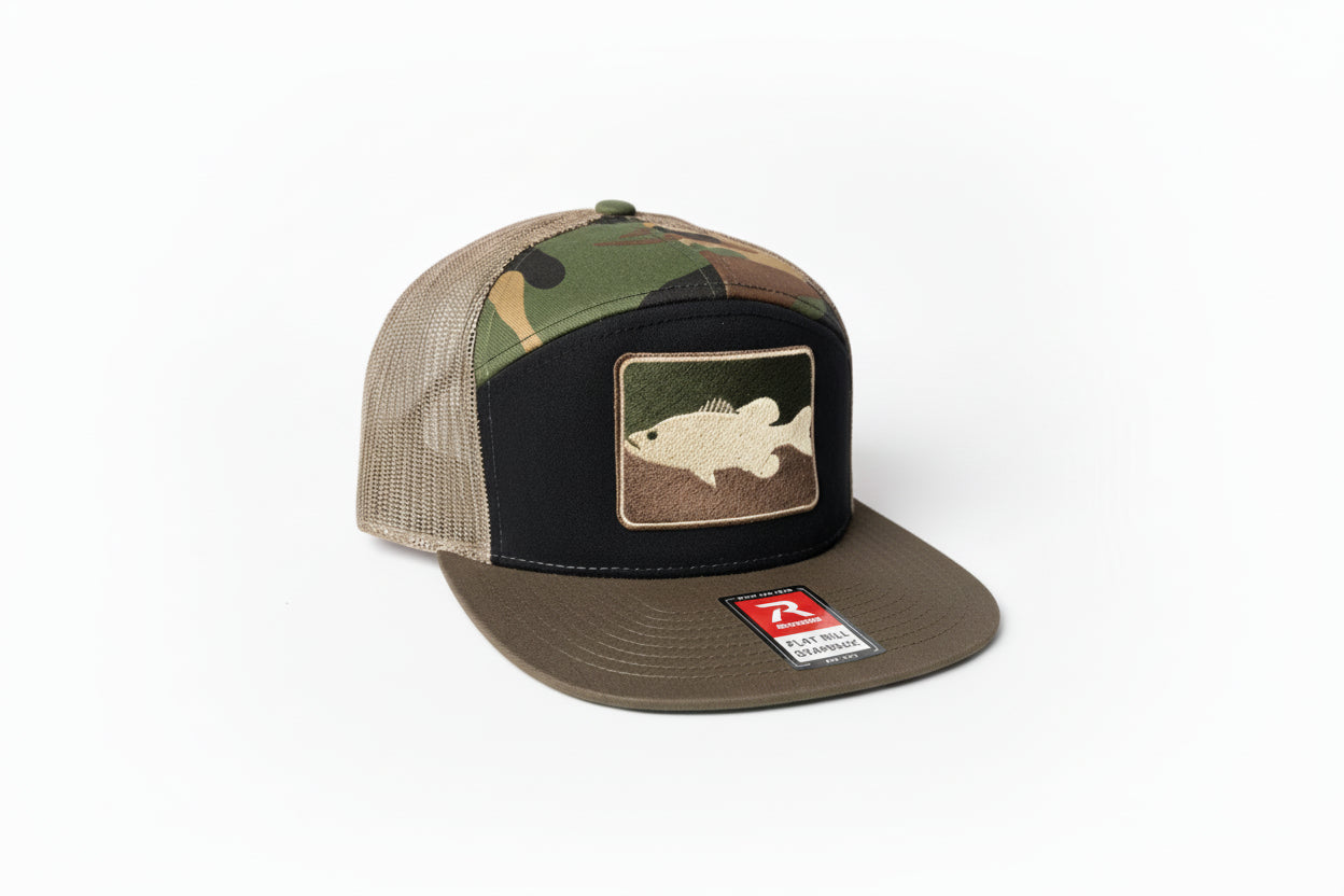 Camouflage trucker hat with fish patch on a dark background