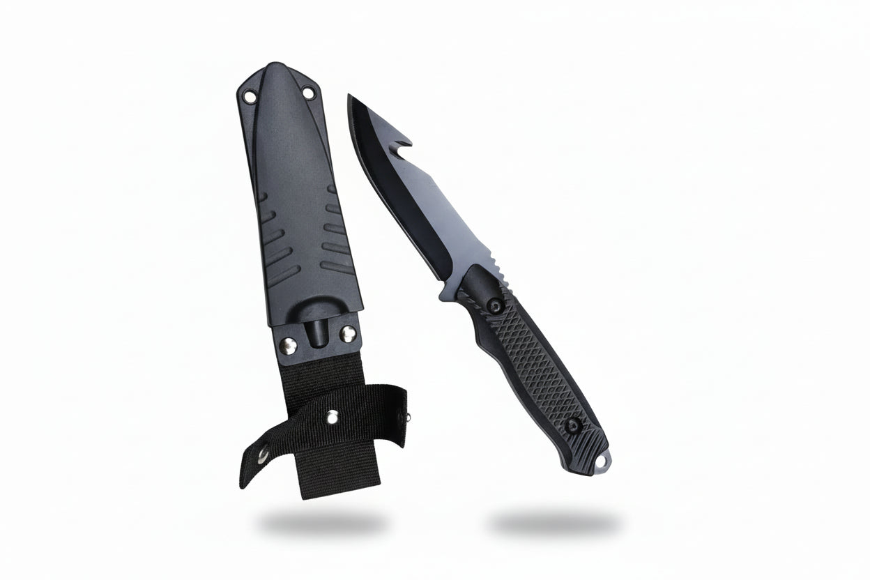 Folding knife with black blade and handle on a wooden surface
