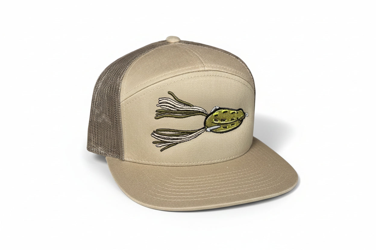 Beige cap with a fishing lure design on a black background